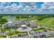 Aerial view of the community clubhouse overlooking a serene lake, golf course, and lush landscaping at 131 Longridge Ln, Ormond Beach, FL 32174