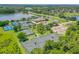 Aerial view of the community tennis courts, clubhouse and a picturesque lake at 131 Longridge Ln, Ormond Beach, FL 32174