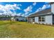 Backyard featuring a screened in lanai, and lush green space at 131 Longridge Ln, Ormond Beach, FL 32174