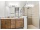 Bathroom showcasing double vanity, a large mirror and a sleek, glass-enclosed shower at 131 Longridge Ln, Ormond Beach, FL 32174