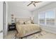 A cozy bedroom featuring a large bed, neutral tones, and plenty of natural light from the window at 131 Longridge Ln, Ormond Beach, FL 32174