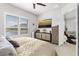 Bedroom featuring a large TV, media cabinet and sitting area overlooking tranquil lake at 131 Longridge Ln, Ormond Beach, FL 32174