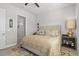 A cozy bedroom featuring a large bed, neutral tones, and plenty of natural light from the window at 131 Longridge Ln, Ormond Beach, FL 32174