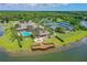 Aerial shot of a luxurious clubhouse, pool area, and pier overlooking the lake at 131 Longridge Ln, Ormond Beach, FL 32174