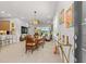 Bright dining area with round table, chandelier, and view of the backyard at 131 Longridge Ln, Ormond Beach, FL 32174