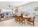 Dining area with stylish light fixture, adjacent to a comfortable living area at 131 Longridge Ln, Ormond Beach, FL 32174