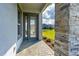 Welcoming entrance featuring a stylish front door and stone accent wall at 131 Longridge Ln, Ormond Beach, FL 32174