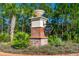 The CreekSide North entrance boasts lush landscaping and a stately brick sign for a welcoming arrival at 131 Longridge Ln, Ormond Beach, FL 32174