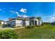 Home with a gray-tone garage door, lush landscaping, and a welcoming walkway at 131 Longridge Ln, Ormond Beach, FL 32174