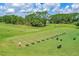 The golf course features a manicured driving range with golfers practicing their swings on a sunny day at 131 Longridge Ln, Ormond Beach, FL 32174