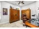 Home office featuring hardwood cabinets, a glass-top desk, and an comfortable executive chair at 131 Longridge Ln, Ormond Beach, FL 32174