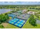 Aerial view of tennis and pickleball courts surrounded by lush landscaping and scenic views at 131 Longridge Ln, Ormond Beach, FL 32174