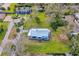 Aerial view of a landscaped property with a metal roof surrounded by lush greenery and neighboring homes at 134 Knight Pl, Daytona Beach, FL 32114