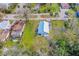 Aerial view of a home with a metal roof surrounded by lush greenery and neighboring properties in a residential area at 134 Knight Pl, Daytona Beach, FL 32114