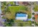 Aerial view of a well-manicured property with a metal roof, landscaping, and a clearly defined boundary line at 134 Knight Pl, Daytona Beach, FL 32114