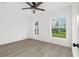 Inviting bedroom with wood-look floors and bright windows overlooking the yard at 134 Knight Pl, Daytona Beach, FL 32114