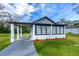 Charming single-story home with a covered front porch, gray driveway, and a lush green lawn at 134 Knight Pl, Daytona Beach, FL 32114