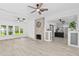 Bright living room features an open floor plan, fireplace, modern ceiling fans and light hardwood flooring at 134 Knight Pl, Daytona Beach, FL 32114