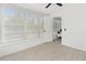 Bright sunroom with tile floors and white walls, enhanced by natural light and a view of the yard at 134 Knight Pl, Daytona Beach, FL 32114