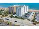 Aerial view of a condo building on the ocean with views of the beach, parking, and neighborhood at 1415 Ocean Shore Blvd # L1, Ormond Beach, FL 32176