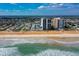 An aerial view shows a condo with beachfront access, where the beach meets the ocean at 1415 Ocean Shore Blvd # L1, Ormond Beach, FL 32176