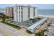 Aerial view of a condo building near the ocean and the parking available for tenants and guests at 1415 Ocean Shore Blvd # L1, Ormond Beach, FL 32176