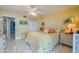 Cozy bedroom with bright walls, tropical artwork, and a comfortable bed at 1415 Ocean Shore Blvd # L1, Ormond Beach, FL 32176