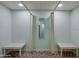 Changing rooms area featuring benches and full length mirror at 1415 Ocean Shore Blvd # L1, Ormond Beach, FL 32176