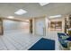 View of the well-lit building lobby, featuring mailboxes, seating, tile floors, and elevator access at 1415 Ocean Shore Blvd # L1, Ormond Beach, FL 32176