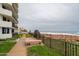 Benches offer scenic views of the beach and ocean from the condo building at 1415 Ocean Shore Blvd # L1, Ormond Beach, FL 32176