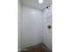 This bathroom shower features white tiling, shelving, and dark-colored flooring at 1415 Ocean Shore Blvd # L1, Ormond Beach, FL 32176