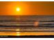 Beautiful sunset view over the ocean with a silhouette of a boat in the distance at 1415 Ocean Shore Blvd # L1, Ormond Beach, FL 32176