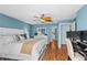 Comfortable bedroom with a desk, a white dresser, and blue walls at 3333 S Atlantic Ave # 1802, Daytona Beach, FL 32118