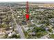 Aerial view of a mature neighborhood with trees and single Gathering homes, located near a lake at 354 Fir St, Ormond Beach, FL 32174