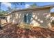 Backyard featuring a wood deck, exterior door, and mature trees at 354 Fir St, Ormond Beach, FL 32174