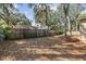 Large backyard enclosed with a wooden fence and featuring mature trees at 354 Fir St, Ormond Beach, FL 32174