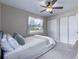 This bedroom has neutral colored walls, a closet, a large window, and a ceiling fan at 354 Fir St, Ormond Beach, FL 32174