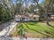 Charming single Gathering home with a well-maintained lawn, driveway, and a cute pink front door at 354 Fir St, Ormond Beach, FL 32174