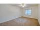 Inviting bedroom featuring a neutral color palette, plush carpeting, and a window with blinds at 4555 S Atlantic Ave # 4609, Port Orange, FL 32127