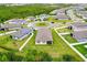 An aerial view shows a home with a large lawn near a cul-de-sac surrounded by green space at 806 Armenia Ct, New Smyrna Beach, FL 32168