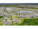 An aerial view shows a home near a cul-de-sac and wooded area in a neighborhood with a lake nearby at 806 Armenia Ct, New Smyrna Beach, FL 32168