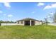 Spacious backyard with screened lanai, lush lawn, and privacy fence, ideal for outdoor living at 806 Armenia Ct, New Smyrna Beach, FL 32168