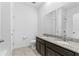 Bathroom featuring granite countertop, dual sinks, and tiled flooring at 806 Armenia Ct, New Smyrna Beach, FL 32168