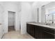 Modern bathroom with granite countertop double vanity, tile floors, and a walk-in shower at 806 Armenia Ct, New Smyrna Beach, FL 32168