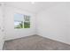 Bright bedroom featuring a window with blinds and neutral carpet at 806 Armenia Ct, New Smyrna Beach, FL 32168