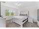 Bright bedroom offers a white bed frame, plush gray carpeting, and an abundance of natural light at 806 Armenia Ct, New Smyrna Beach, FL 32168