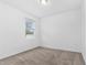 Neutral bedroom featuring neutral carpet and a window with blinds at 806 Armenia Ct, New Smyrna Beach, FL 32168