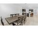 Elegant dining room with a large wooden table and chairs, adjacent to the modern kitchen at 806 Armenia Ct, New Smyrna Beach, FL 32168