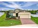 Charming single-story home with a well-manicured lawn and a brick driveway at 806 Armenia Ct, New Smyrna Beach, FL 32168