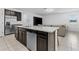 Modern kitchen island featuring granite countertops, stainless steel appliances, and a breakfast bar at 806 Armenia Ct, New Smyrna Beach, FL 32168